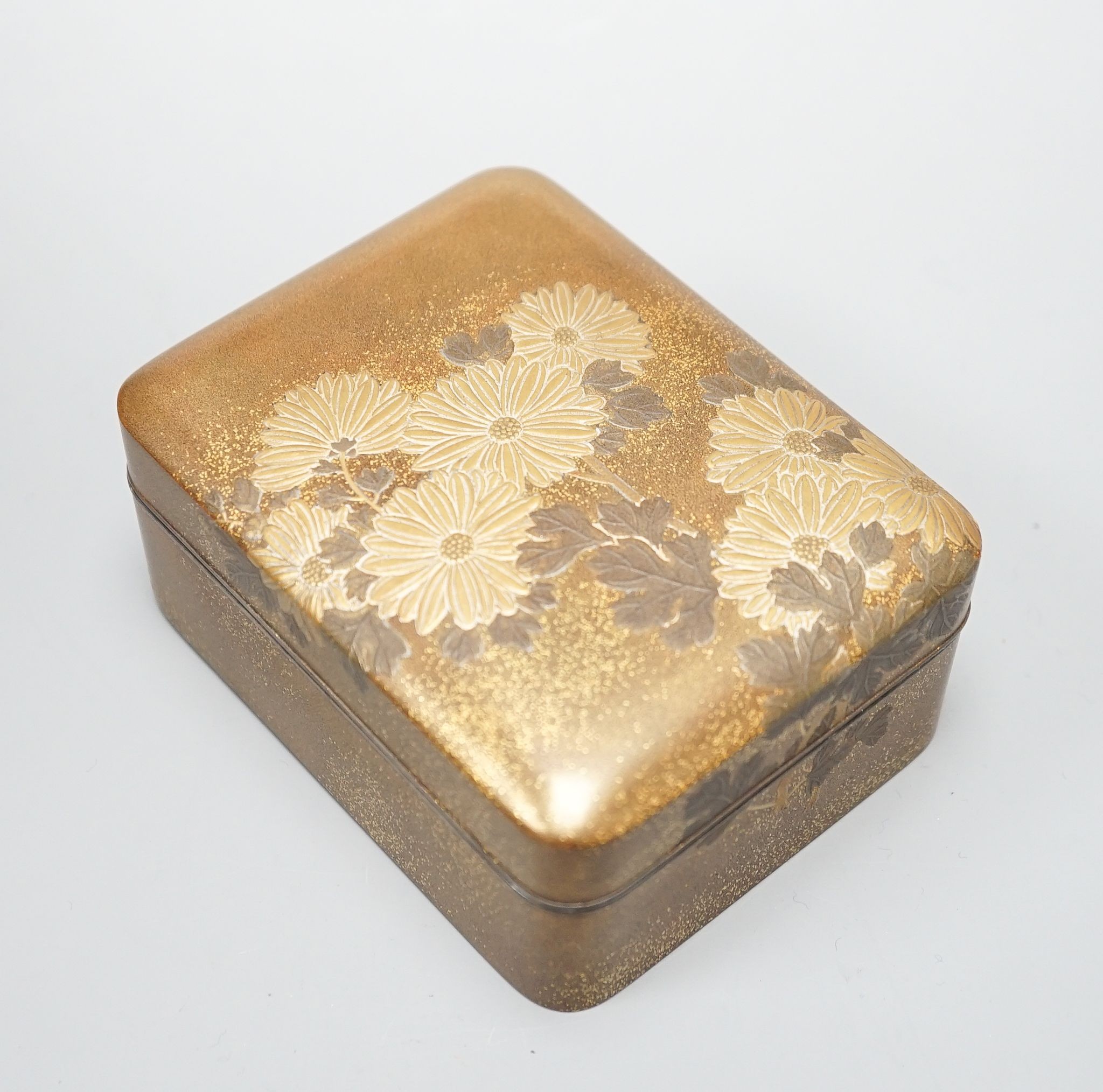 A Japanese small rectangular hiramakline (?) gold-ground box and cover decorated with chrysanthemums, 10 x 8cm